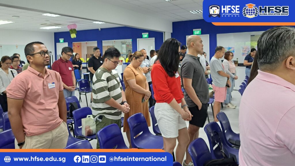 A group of parents bowing their heads during a conference.