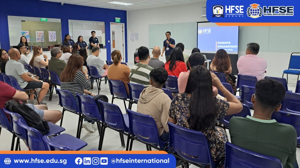 A group of parents attending a conference or talk session in a classroom.