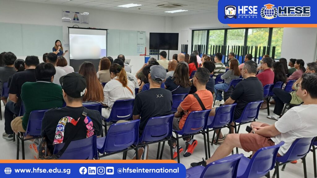 A group of parents listening attentively during a talk session in a classroom.