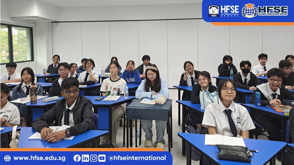 A group of students in Singapore seated at their blue triangular desks.