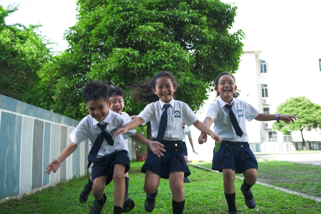 HFSE International School Primary students in Singapore having fun outside.