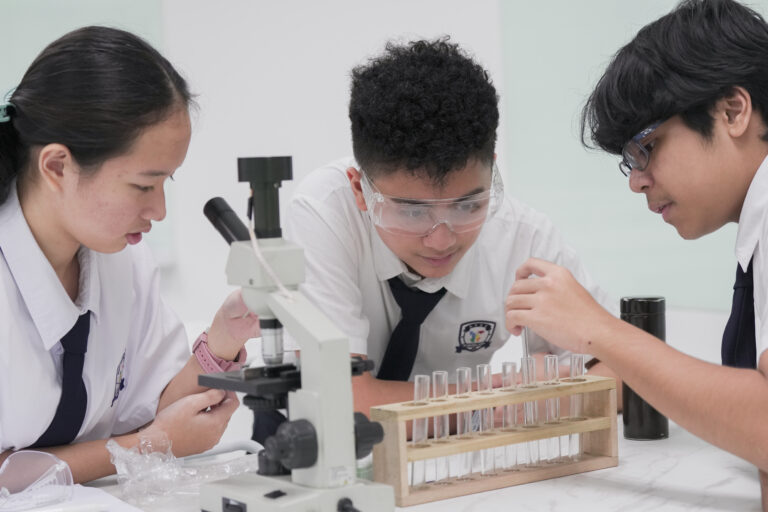 HFSE International School Secondary students working on a science project.