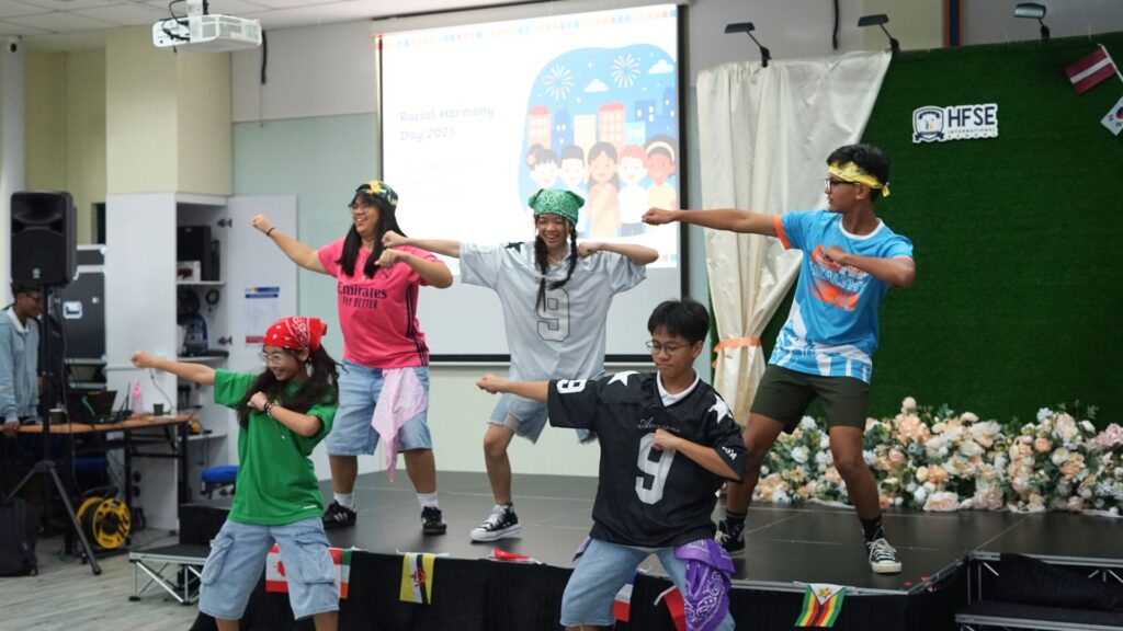 A group of primary school students in Singapore dancing on stage.